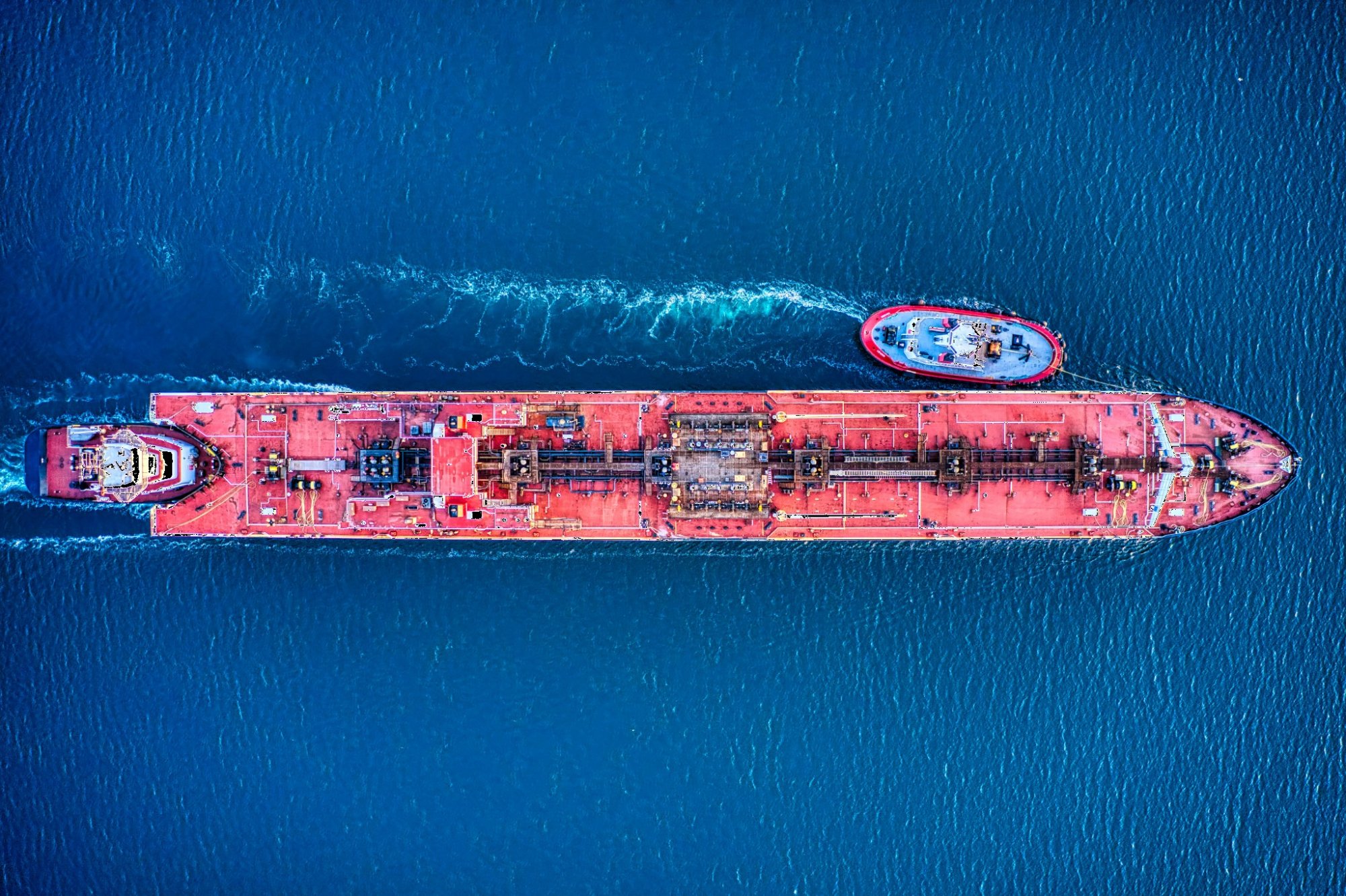 A product tanker under tug escort, seen from directly above.